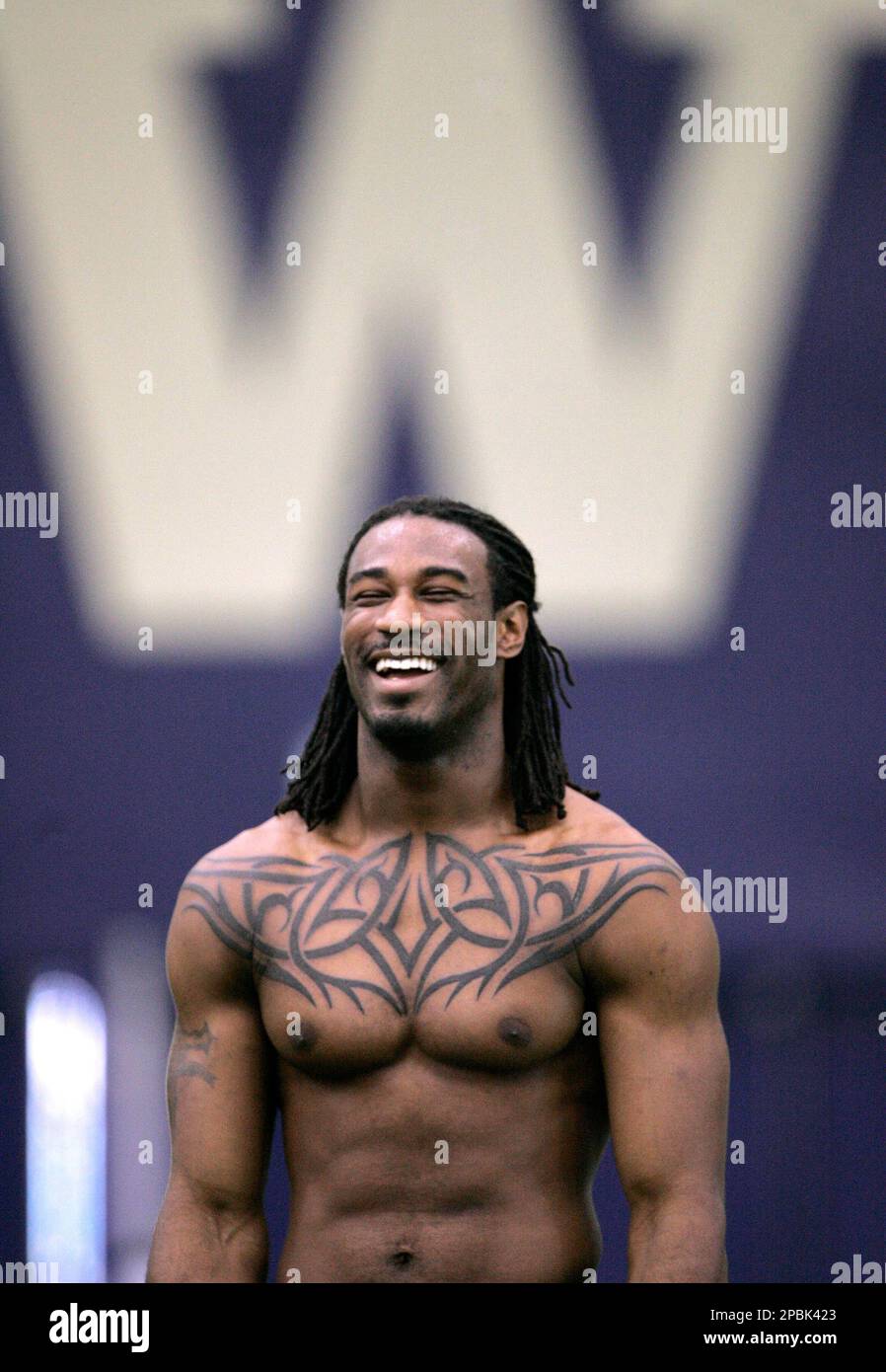 Former Washington quarterback Isaiah Stanback, sporting a new tattoo across  his chest, smiles as he takes a break during a light workout Wednesday,  April 25, 2007, at the school's indoor football facility, image size:898x1390