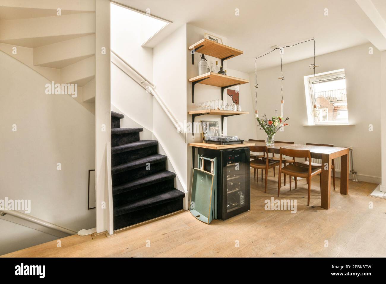 a living room with stairs and a table on the floor in front of the