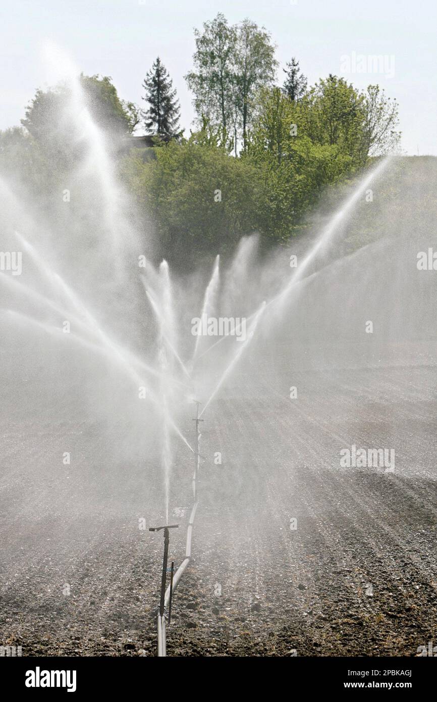 Sprinklers water a field in Air-la-Ville, near Geneva, Switzerland,  Tuesday, April 24, 2007. After weeks of extremly high temperatures for the  time of the year, combined with drought, many Swiss farmers have