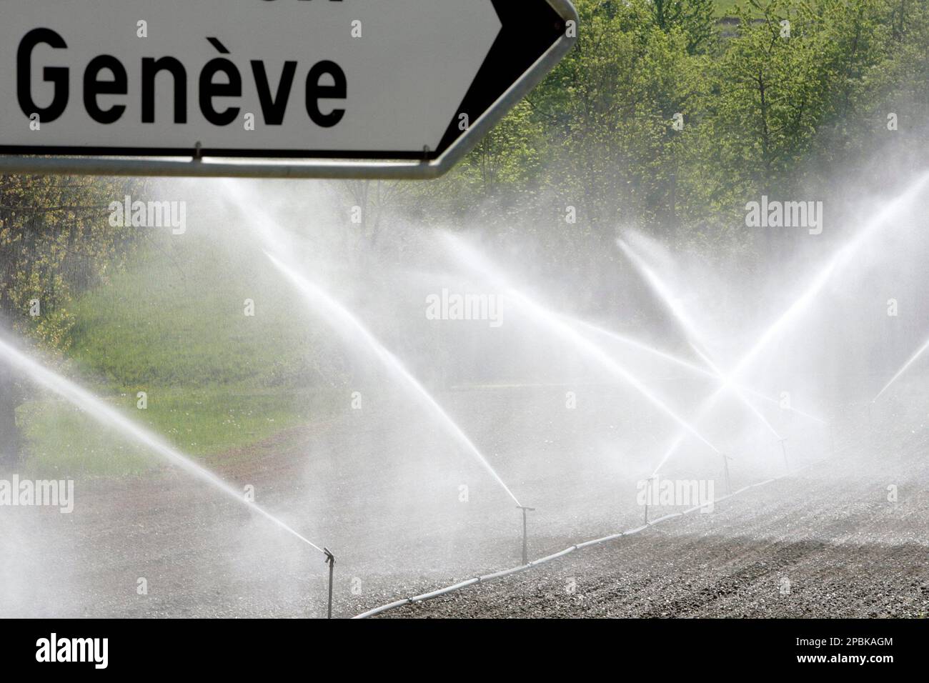 Sprinklers water a field in Air-la-Ville, near Geneva, Switzerland,  Tuesday, April 24, 2007. After weeks of extremly high temperatures for the  time of the year, combined with drought, many Swiss farmers have