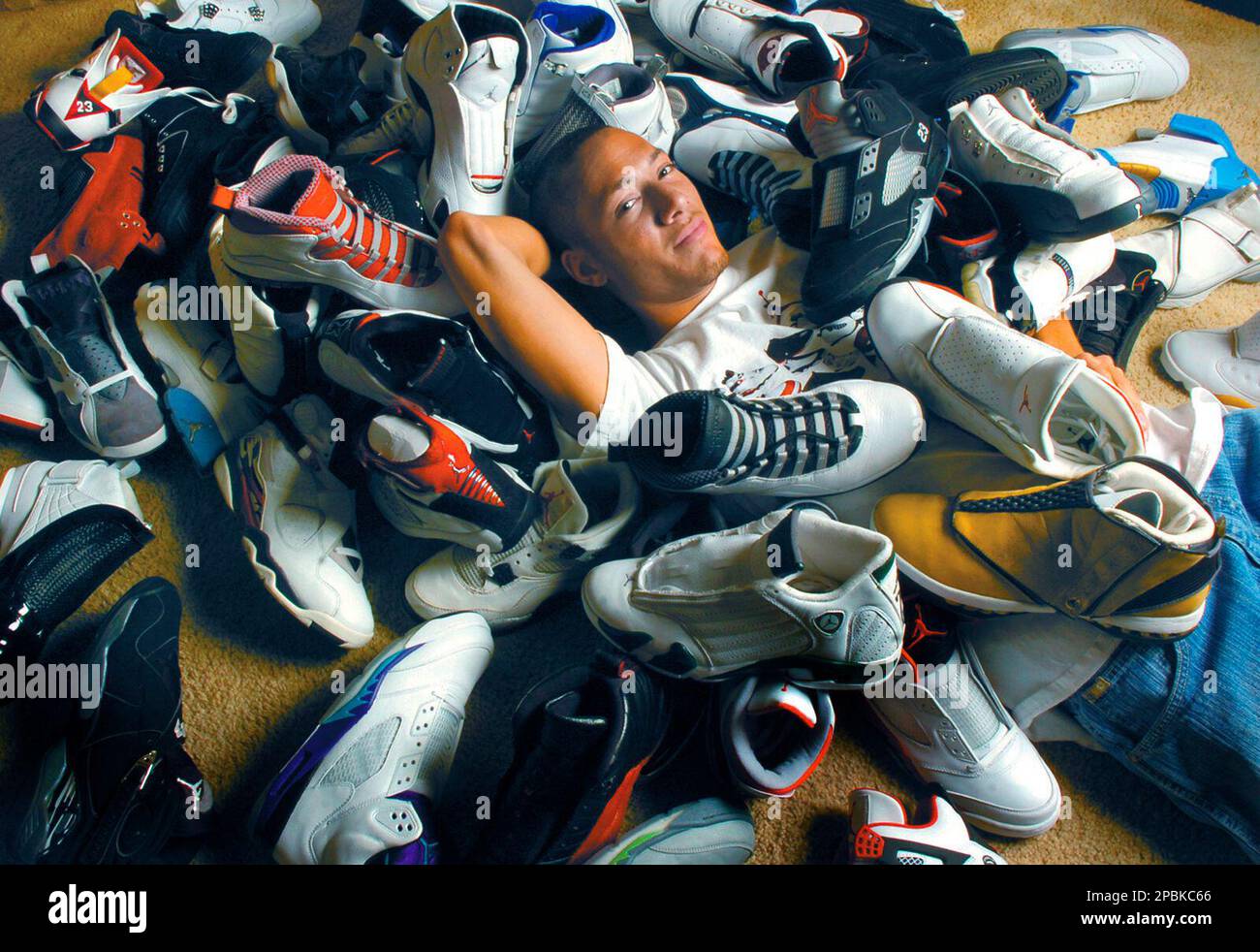 Texas Tech hurdler Bryan Scott sits amid his collection of Nike Air Jordan  basketball shoes, April 9, 2007, in Lubbock, Texas. Scott is addicted.  There's really no other way to put it.