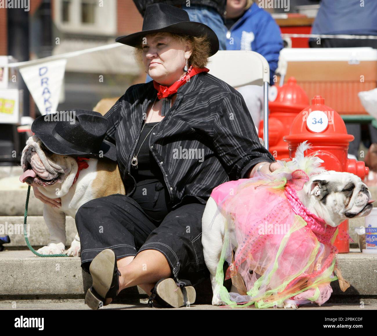 Lorna Keeling, of Clarion, Iowa, sits with here bulldogs Lance, left, and Miss Lilly Jean during