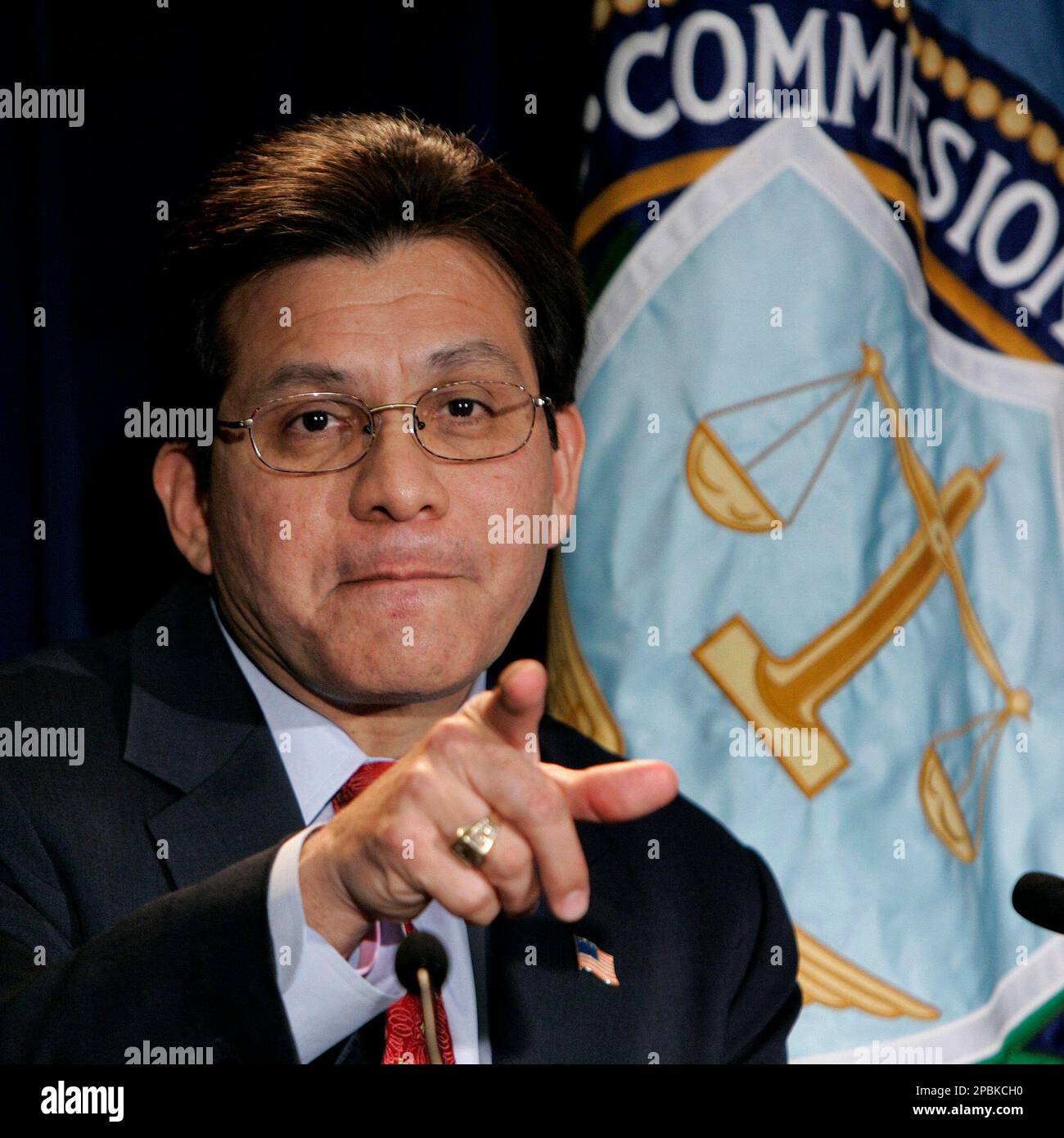 Attorney General Alberto Gonzales calls on a reporter during a news