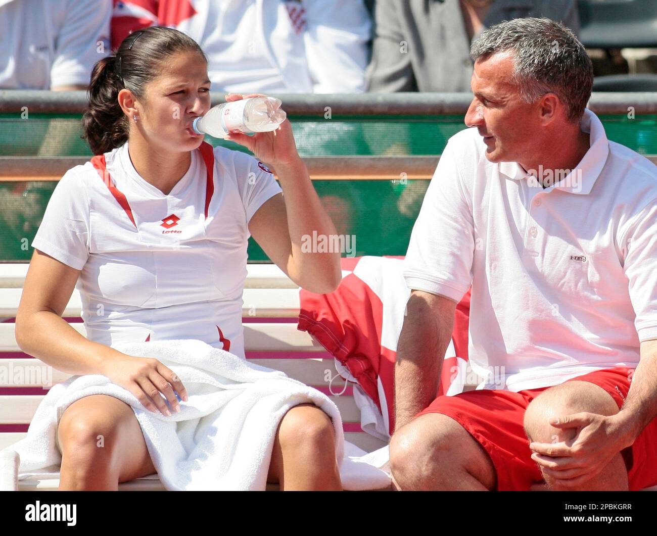 Jelena Kostanic-Tosic from Croatia, left, sits next to team captain Goran Prpic during a pause of her match against Anna-Lena Groenefeld from Germany at the World Group II 2007 first round Tennis Fed Cup competition between Germany and Croatia in Fuerth, southern Germany, Sunday, April 22, 2007. Groenefeld later won in 6-4, 6-3. (AP Photo/Uwe Lein) Stock Photo