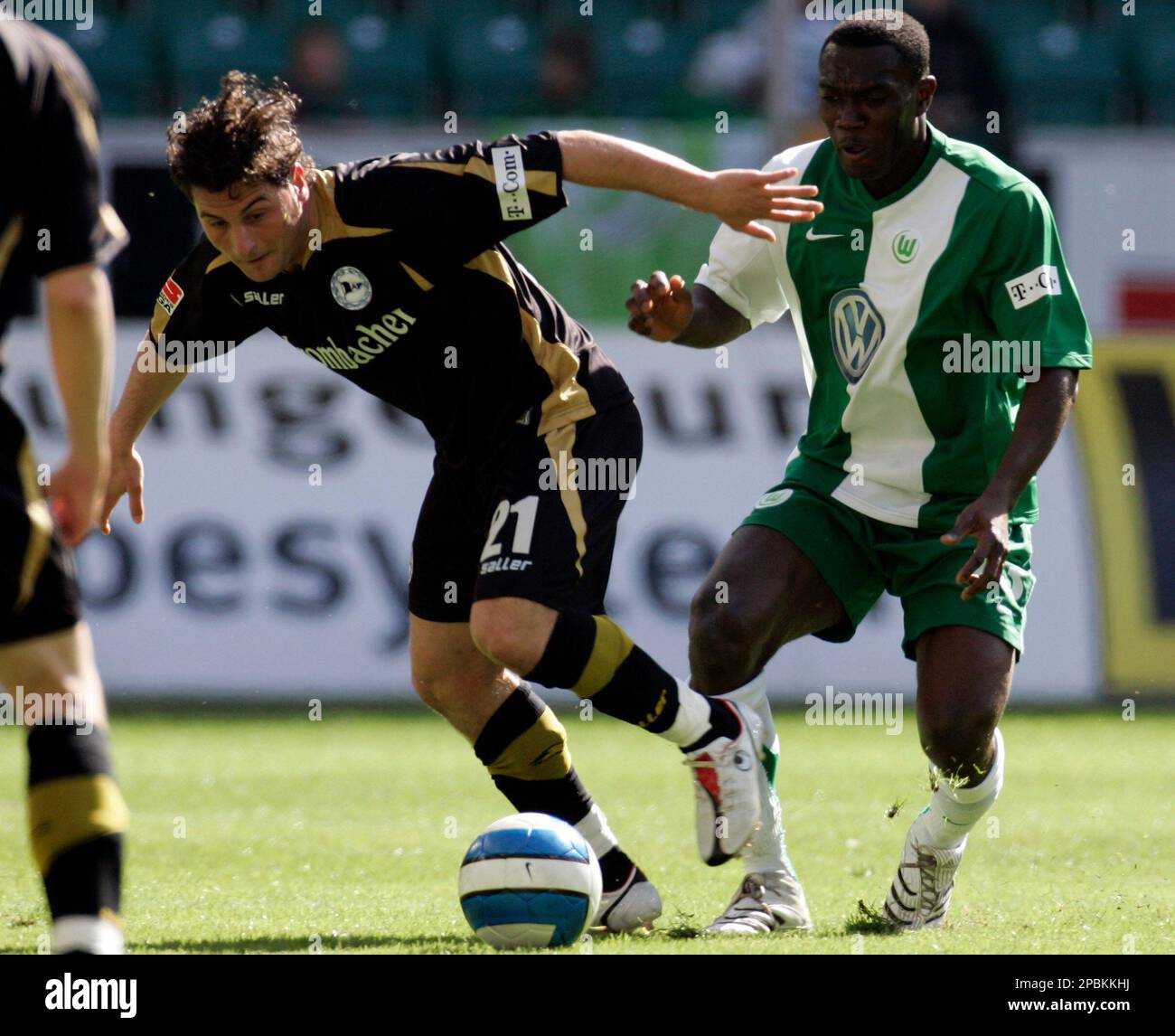 Wolfsburg's Isaac Boakye from Ghana, left, is attacked by Stuttgart's Cacau  from Brazil during a German Soccer Federation DFB cup semifinal match VfL  Wolfsburg against VfB Stuttgart in Wolfsburg, northern Germany, on