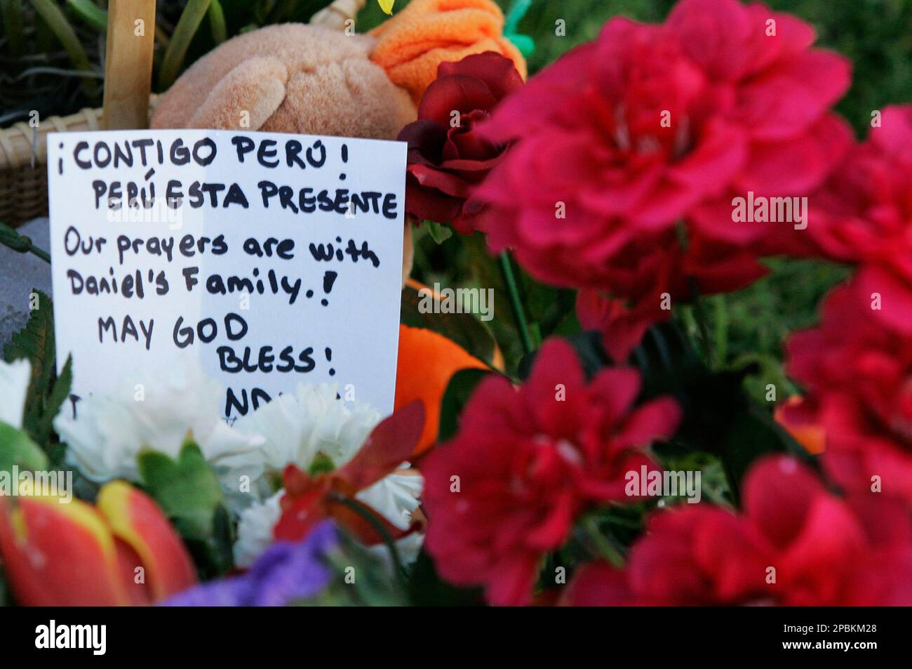 Flowers and messages grace the makeshift memorial in front of Burruss Hall on the campus of