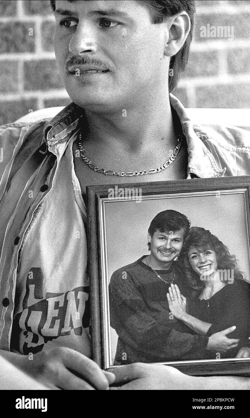 ** FILE ** Eric Beiswenger of Lorain, Ohio, holds a photo of himself and Lisa Filiaggi, in this