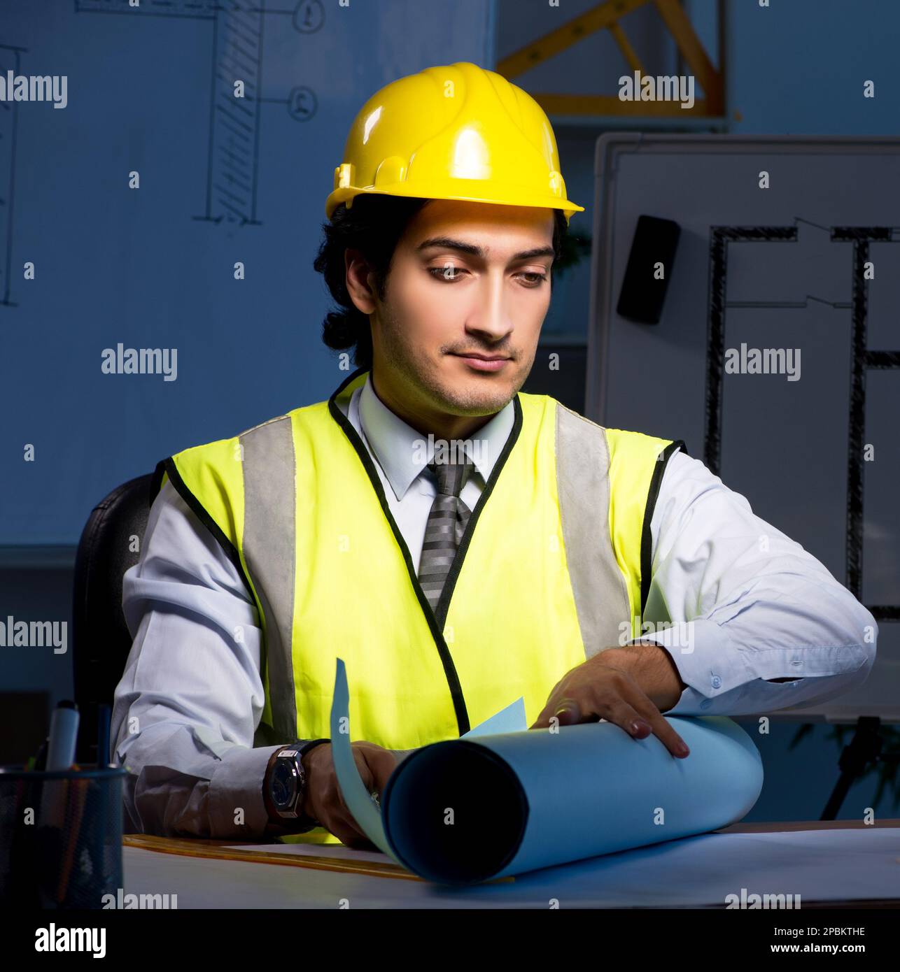 The young construction architect working on project at night Stock