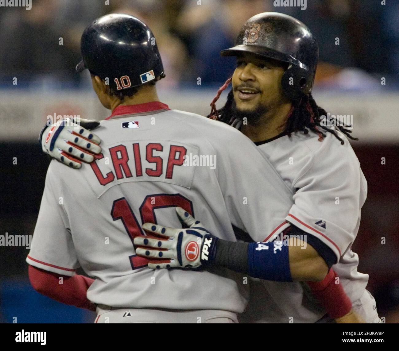 Boston Red Sox Manny Ramirez, right, is greeted by Coco Crisp after hitting  a two run homer in the eighth inning to tie the game during AL baseball  action against the Toronto