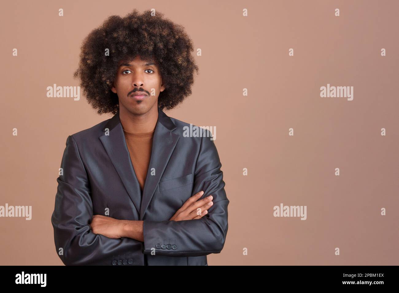 Serious stylish african man wearing a jacket looking at camera Stock Photo