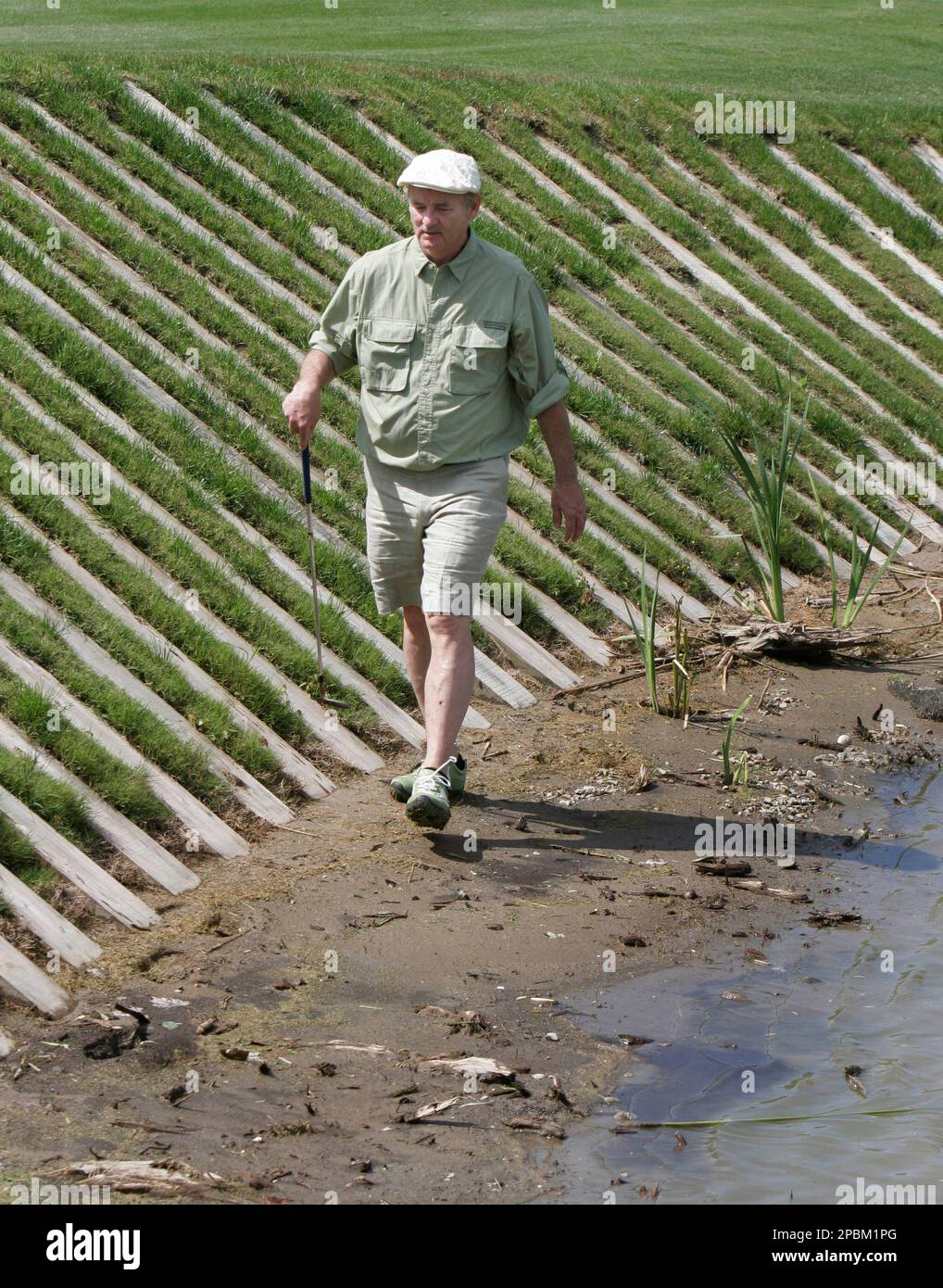 Actor Bill Murray goes in search of his ball near the water hazard at the  ninth green during the Pro-Am of the Zurich golf classic in Avondale, La.,  Wednesday, April 18, 2007.(AP