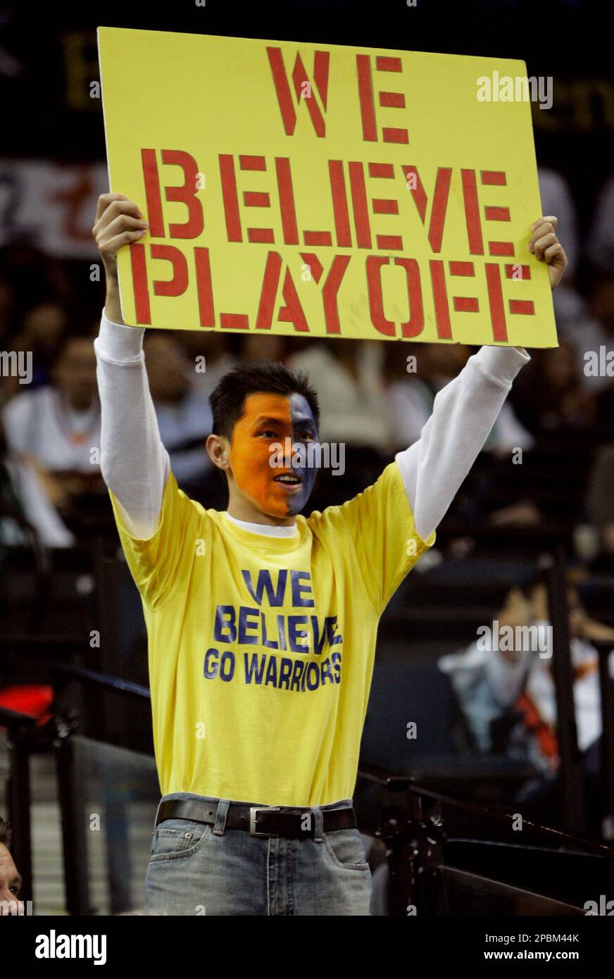 Golden State Warriors fan Paul Wong holds up a sign before the