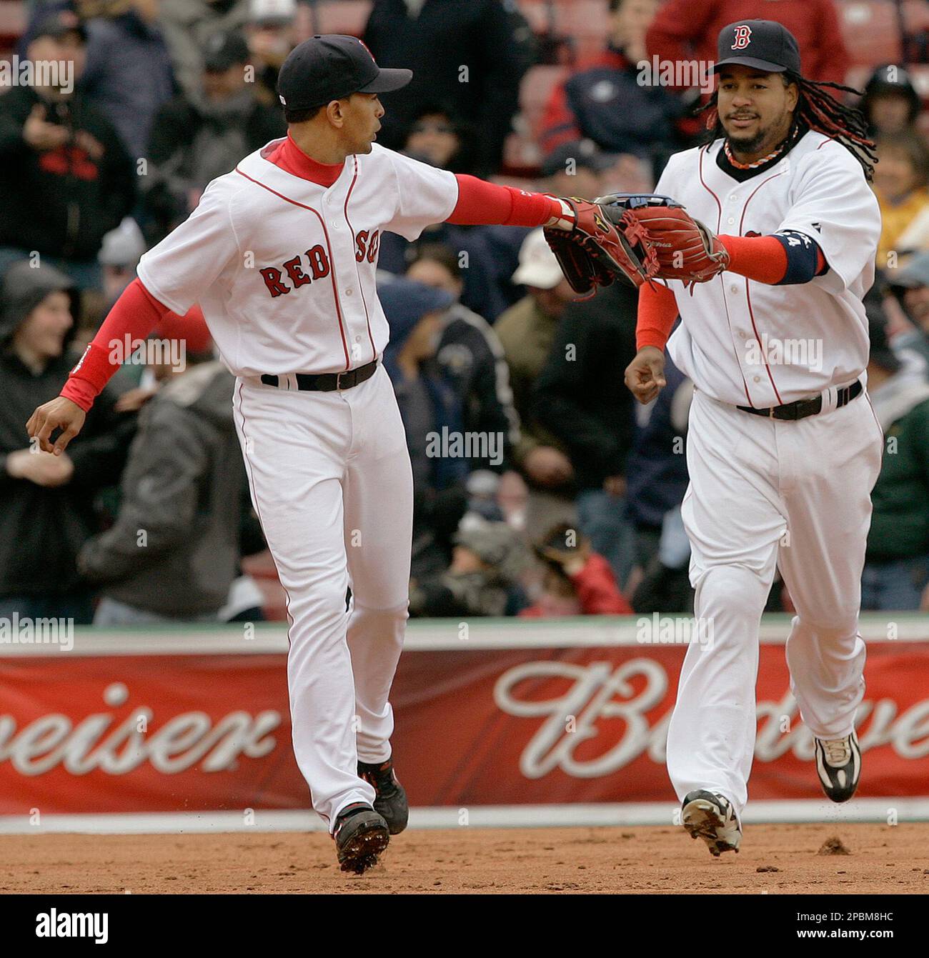 Boston Red Sox left fielder Manny Ramirez, right, and shortstop Julio Lugo  touch gloves after Ramirez caught a fly ball to end the second inning  during a baseball game against the Los