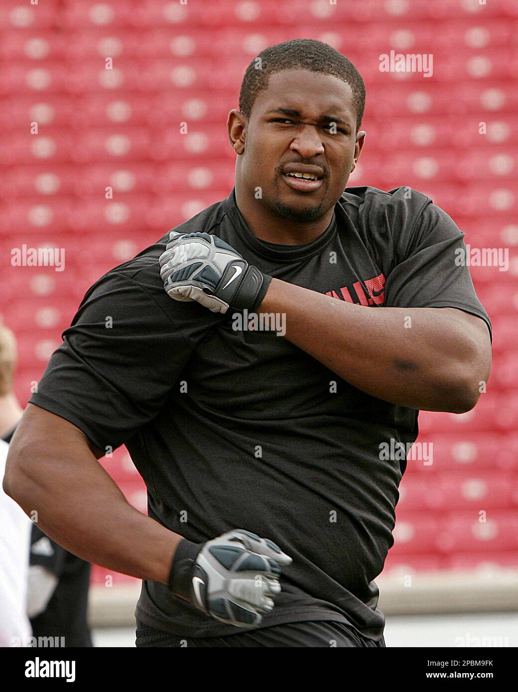 Louisville lineman Amobi Okoye stretches as he prepares to show off his