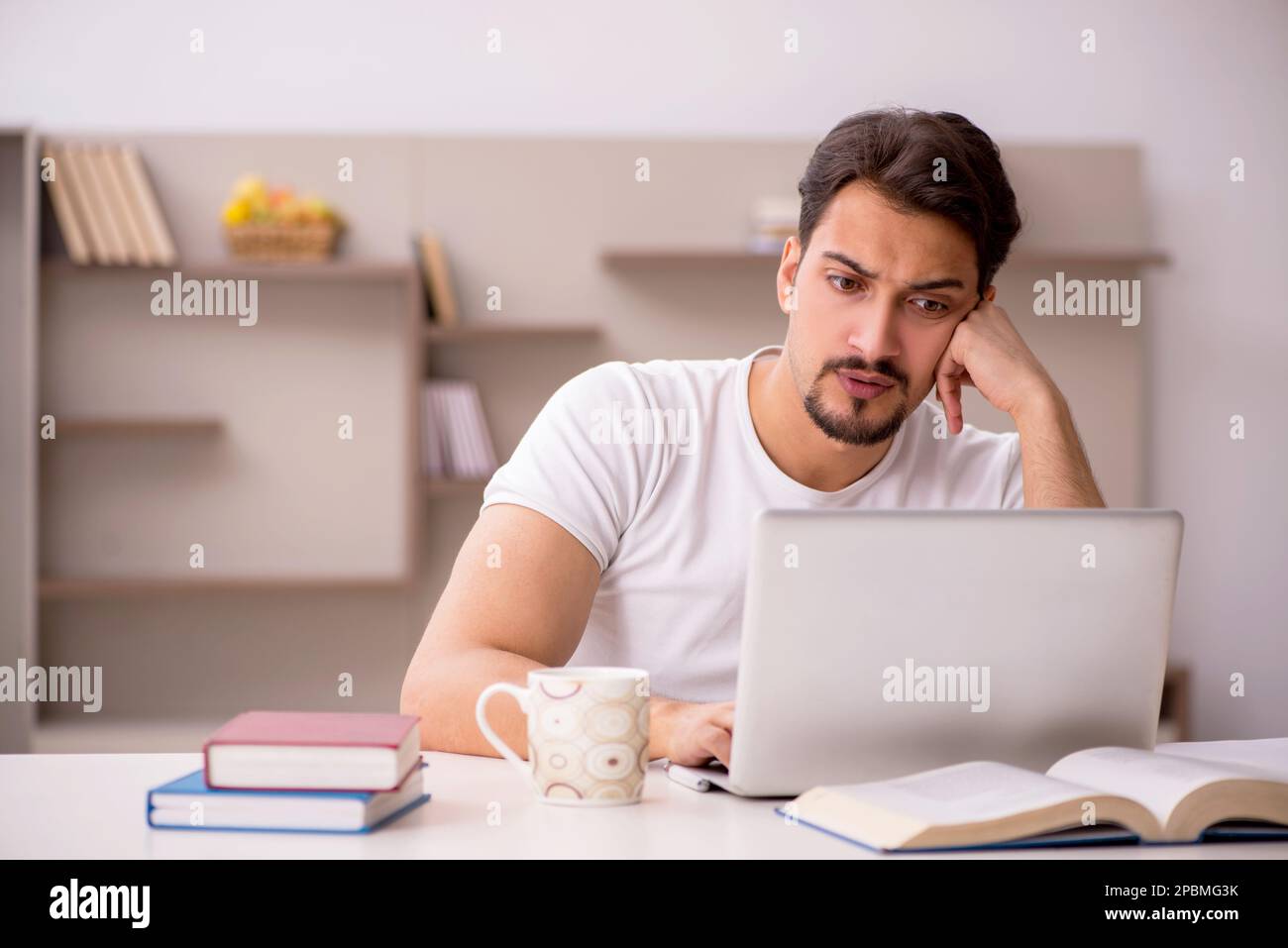 Young student studying at home during pandemic Stock Photo - Alamy