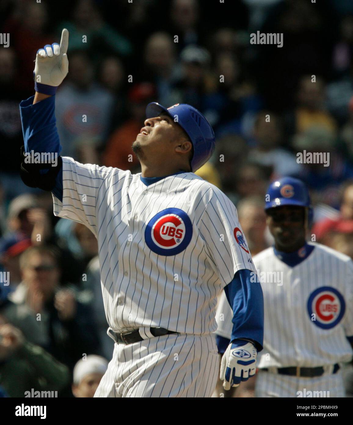 Chicago Cubs' Carlos Zambrano points to the sky as he crosses home plate  after hitting a home run during the fourth inning of a baseball game  against the Cincinnati Reds, Friday, April