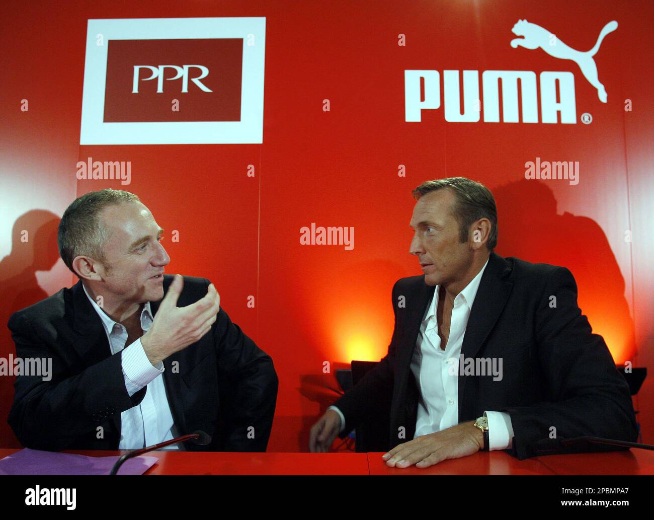 Francois-Henri Pinault, Chairman and Chief Executive of French luxury goods  PPR Group, left, and Jochen Zeitz, CEO of German sports goods maker Puma,  right, talk prior to a news conference in Nuremberg,