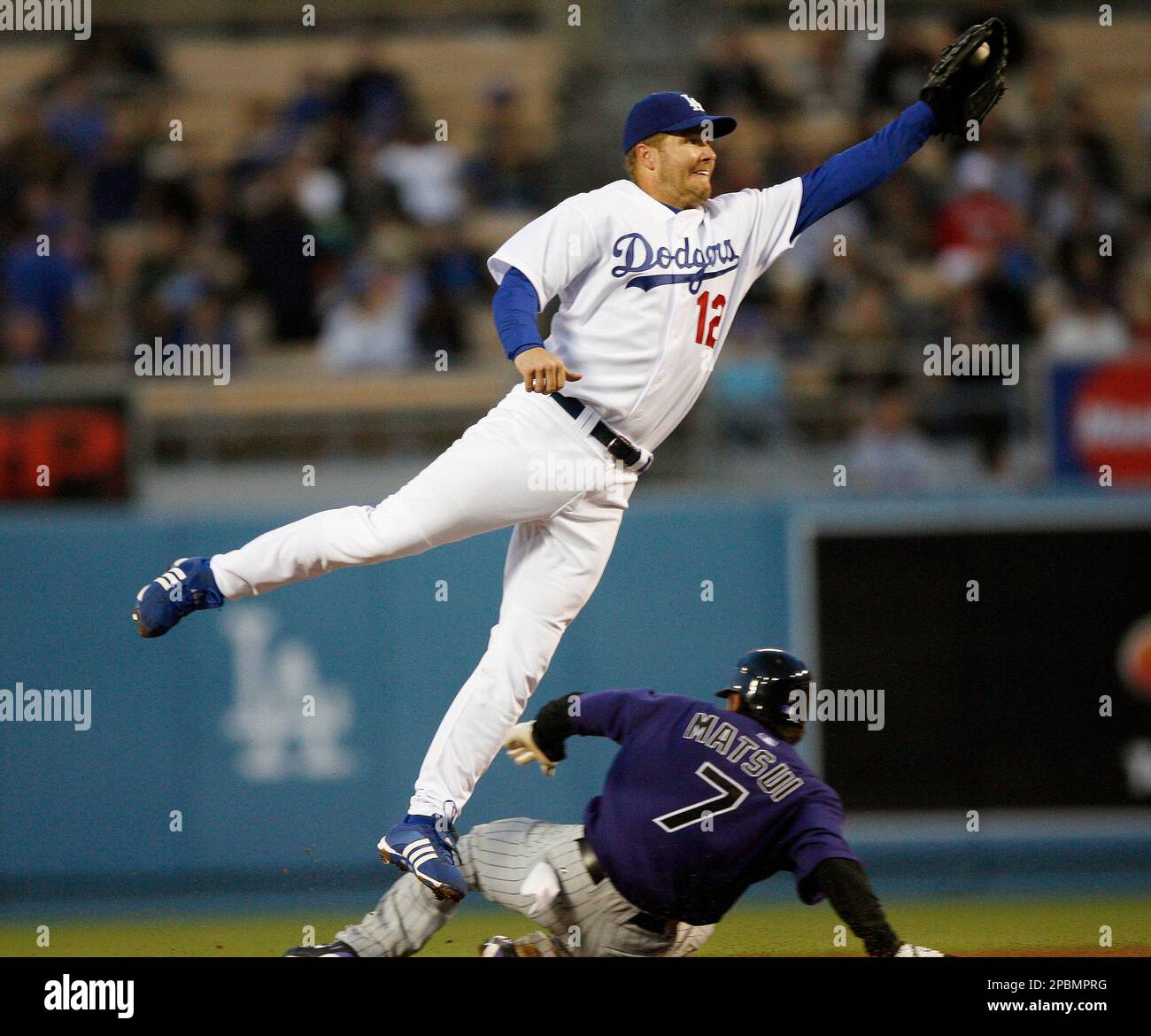 Los Angeles Dodgers second baseman Jeff Kent (12) stretches to catch the  high throw from catcher Russell Martin as Colorado Rockies' Kazuo Matsui,  of Japan, steals second base during the first inning