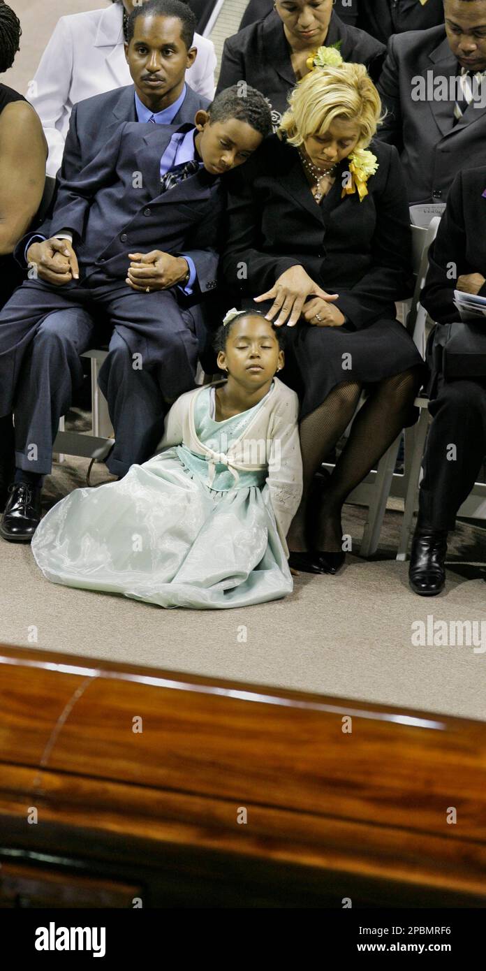 Eddie Robinson III, holds his son Eddie Robinson IV, with his wife