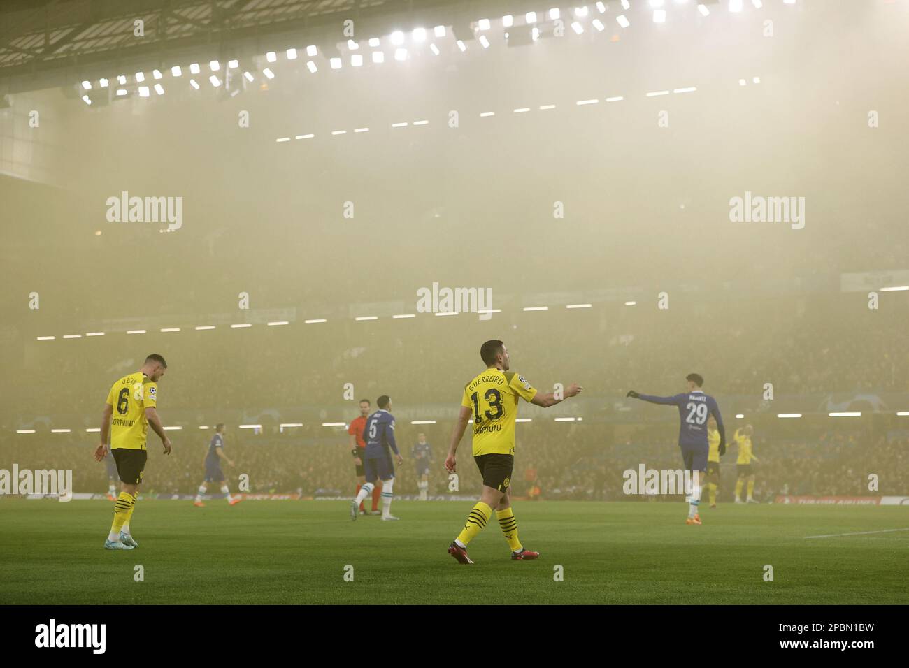 Stamford Bridge, London, United Kingdom, March 07, 2023, Players on the pitch after fans threw a smoke bomb  during  Chelsea FC vs Borussia Dortmund - Stock Photo