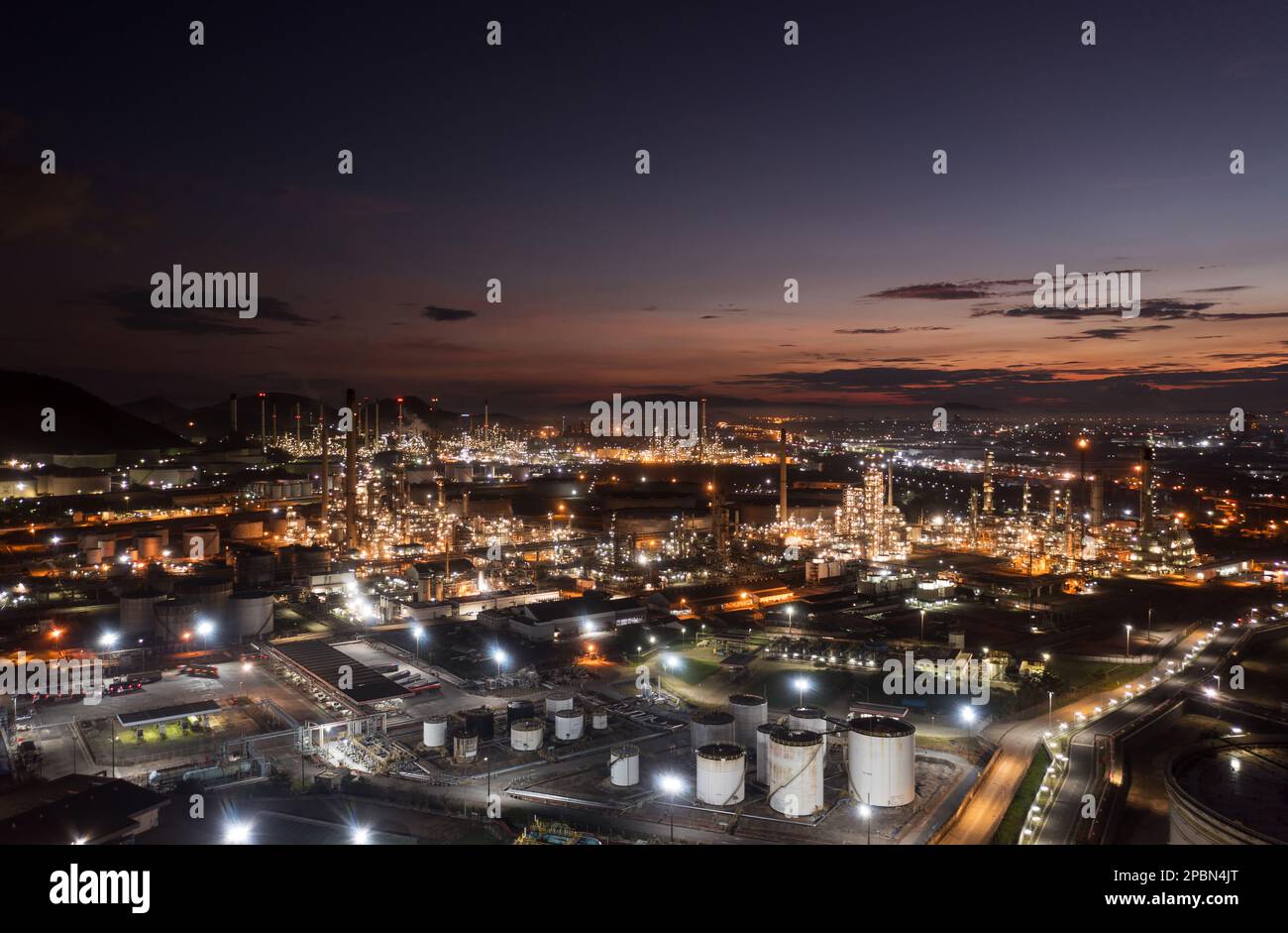 Aerial view drone of oil storage tank with oil refinery factory industrial. Oil refinery plant at beautiful sky sunset and twilight. industry factory Stock Photo
