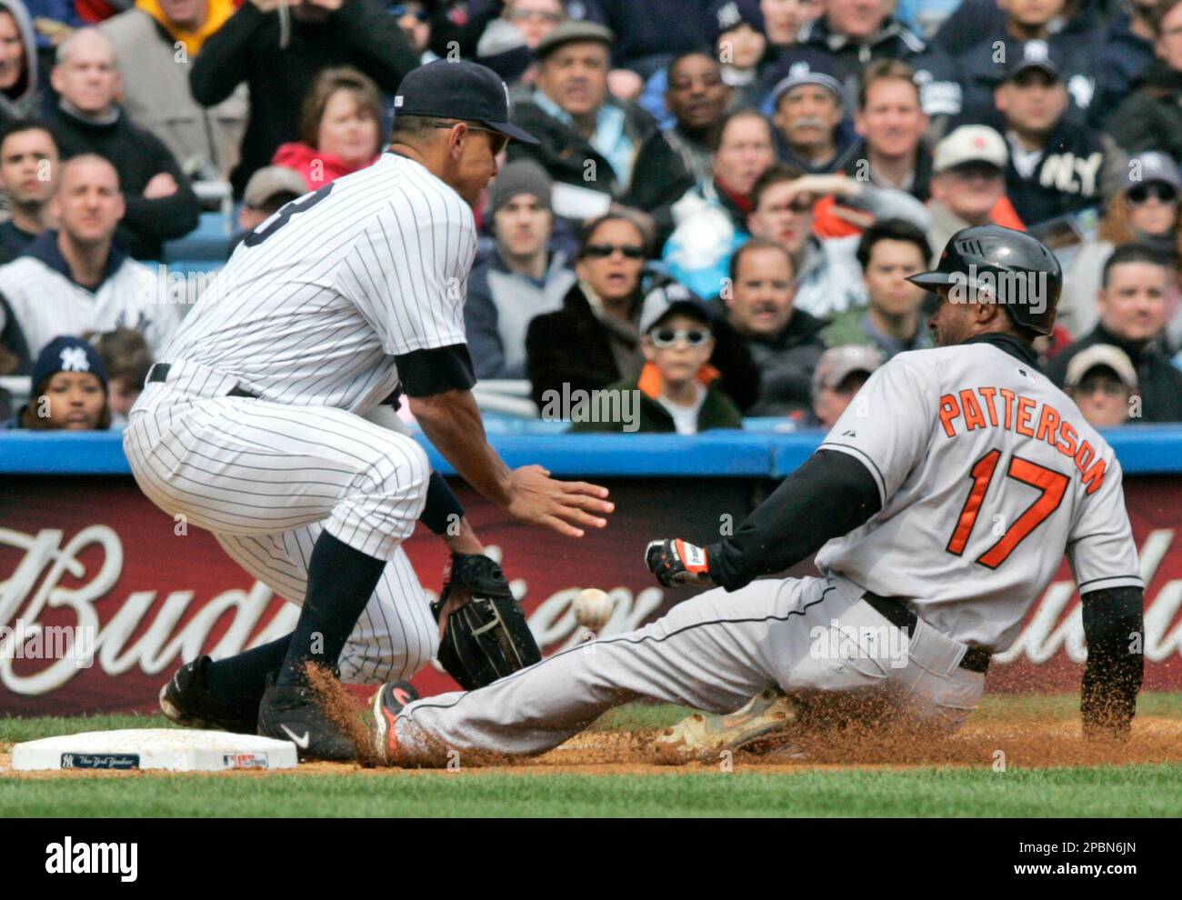 Baltimore Orioles' Corey Patterson (17) slides to beat the throw to third  base as New York Yankees' Alex Rodriguez (13) waits for the ball during the  third inning of baseball action Saturday