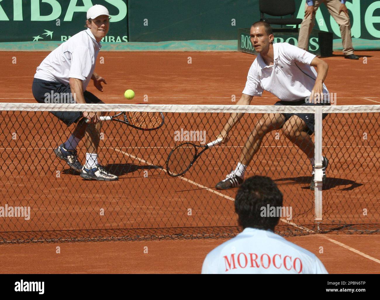 Danish team Rasmus Norby, left, and Frederik Nielsen, right, return the  ball to Morocco's Mounir El Aarej, foreground, and Rabie Charki, unseen,  during their Davis Cup Europe/Africa Zone play off tennis match