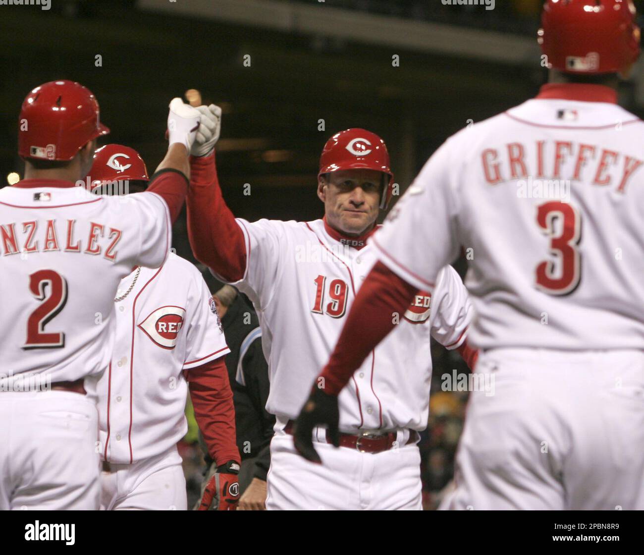 Cincinnati Reds' Ken Griffey Jr. (3) is congratulated by Alex Gonzalez (2)  after Griffey hit a two-run home run off Milwaukee Brewers pitcher Dave  Bush in the second inning of a baseball