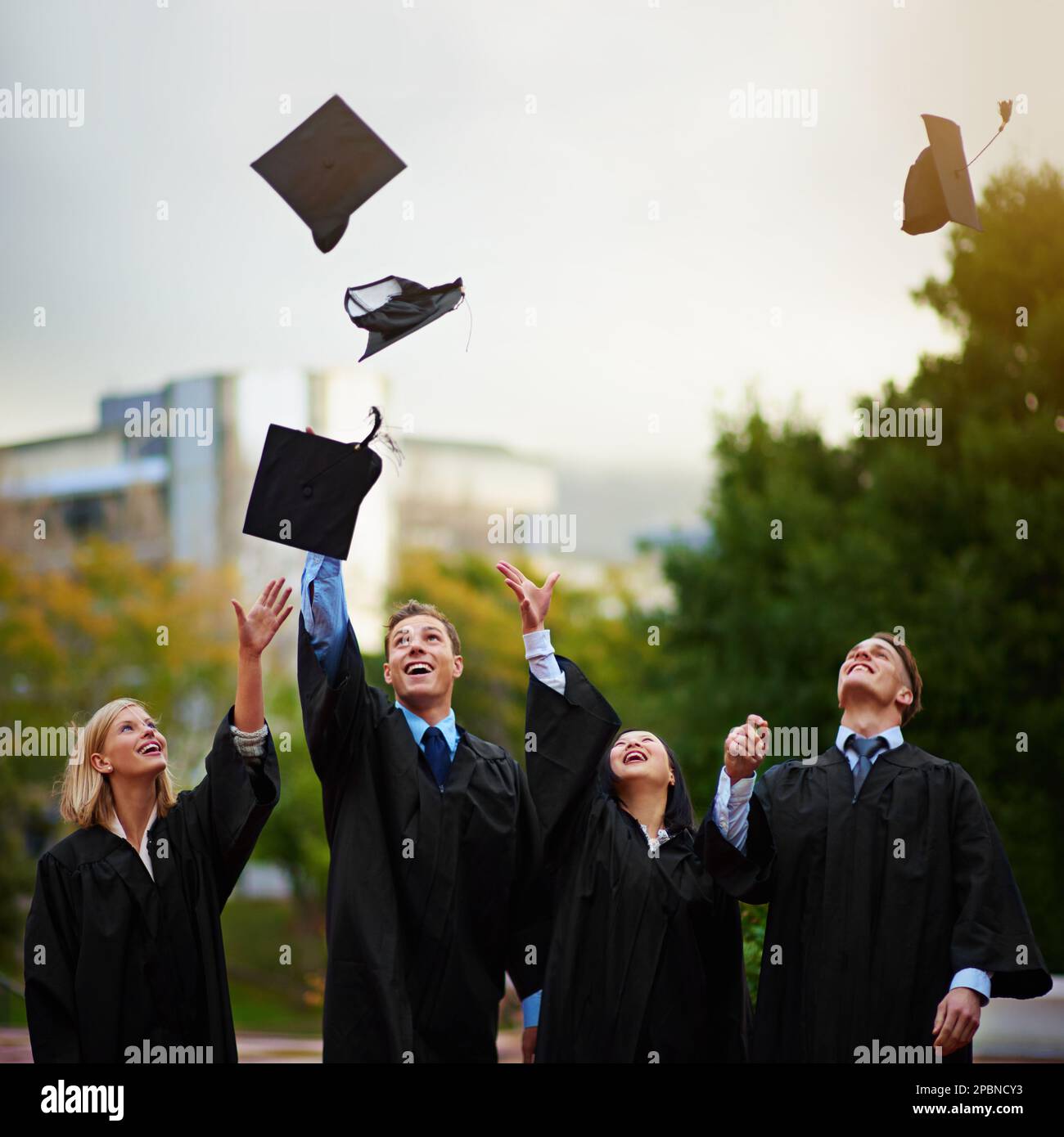 The tassel was worth the hassle. A group of students throwing their ...