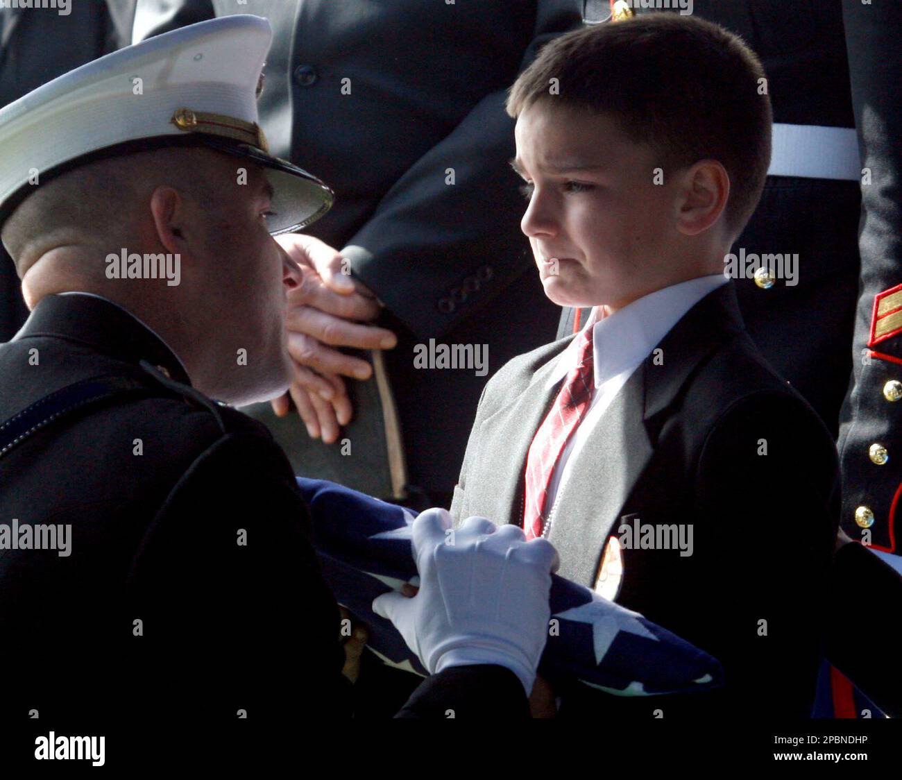 Christian Golczynski, 8, receives the flag that covered the coffin 