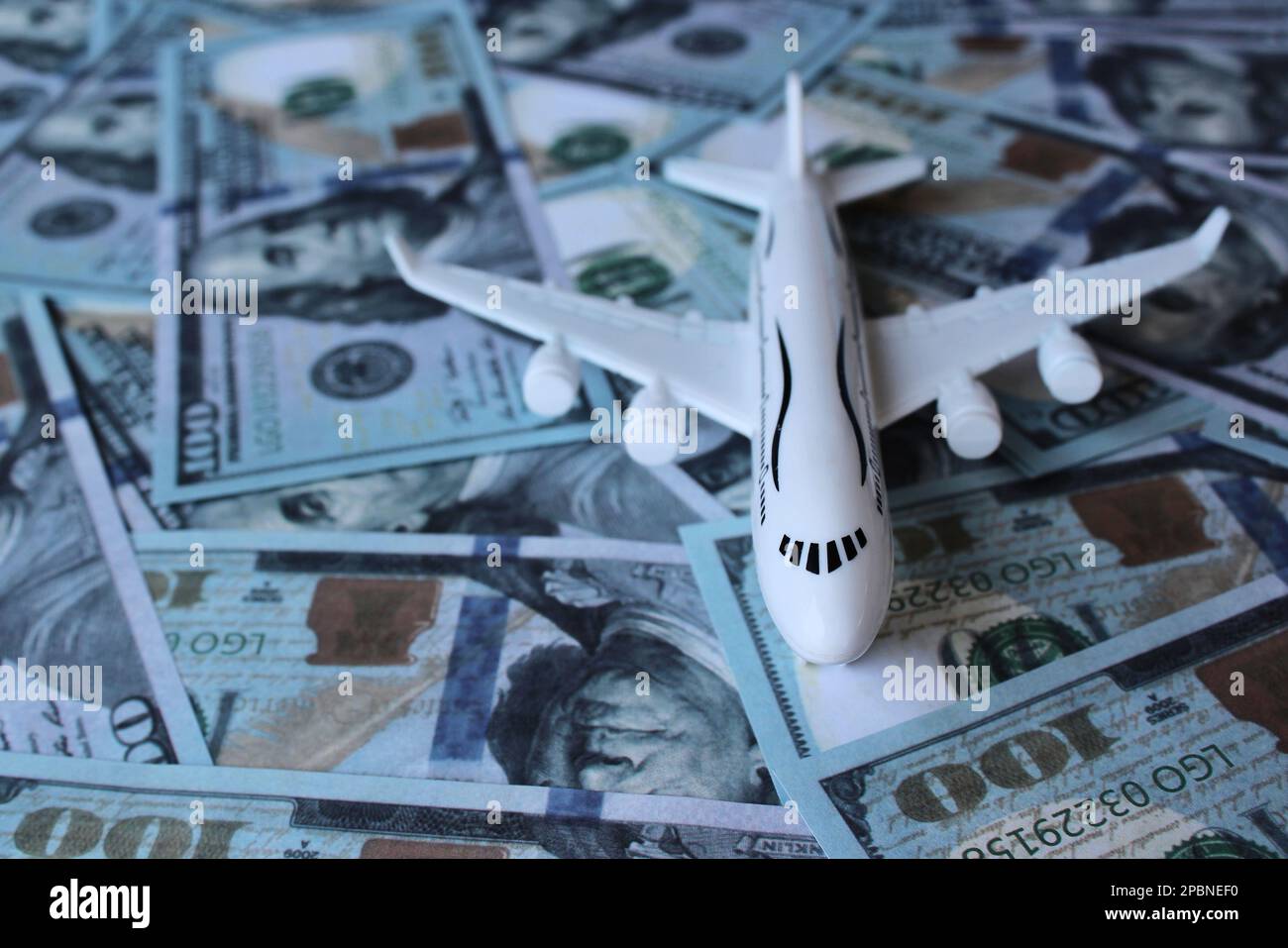 Selective focus image of toy plane and money. Transportation and aviation industry concept Stock Photo