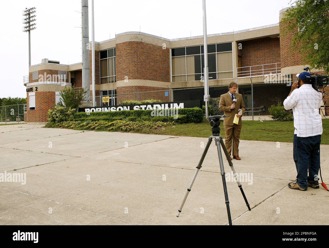 A reporter stands outside Grambling State University's Robinson Stadium