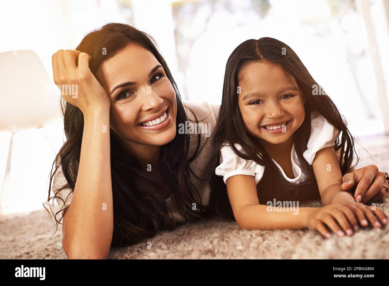 Like two peas in a pod. Cropped portrait of a happy mother and daughter at home. Stock Photo