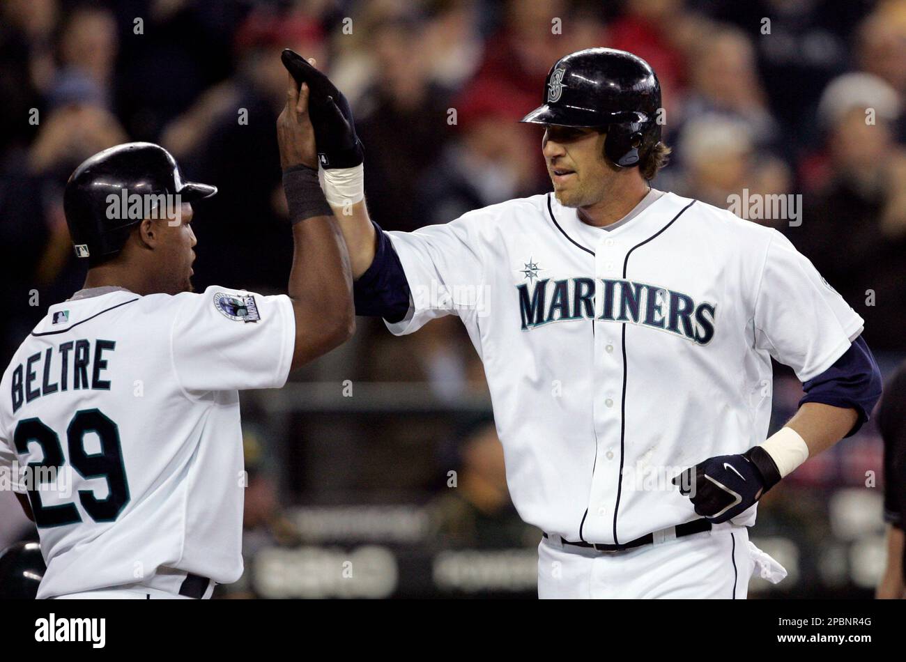 Seattle Mariners' Richie Sexson, right, is greeted at home by Adrian Beltre  following Sexson's seventh inning home run against the Oakland Athletics  during opening day at a baseball game, Monday, April 2