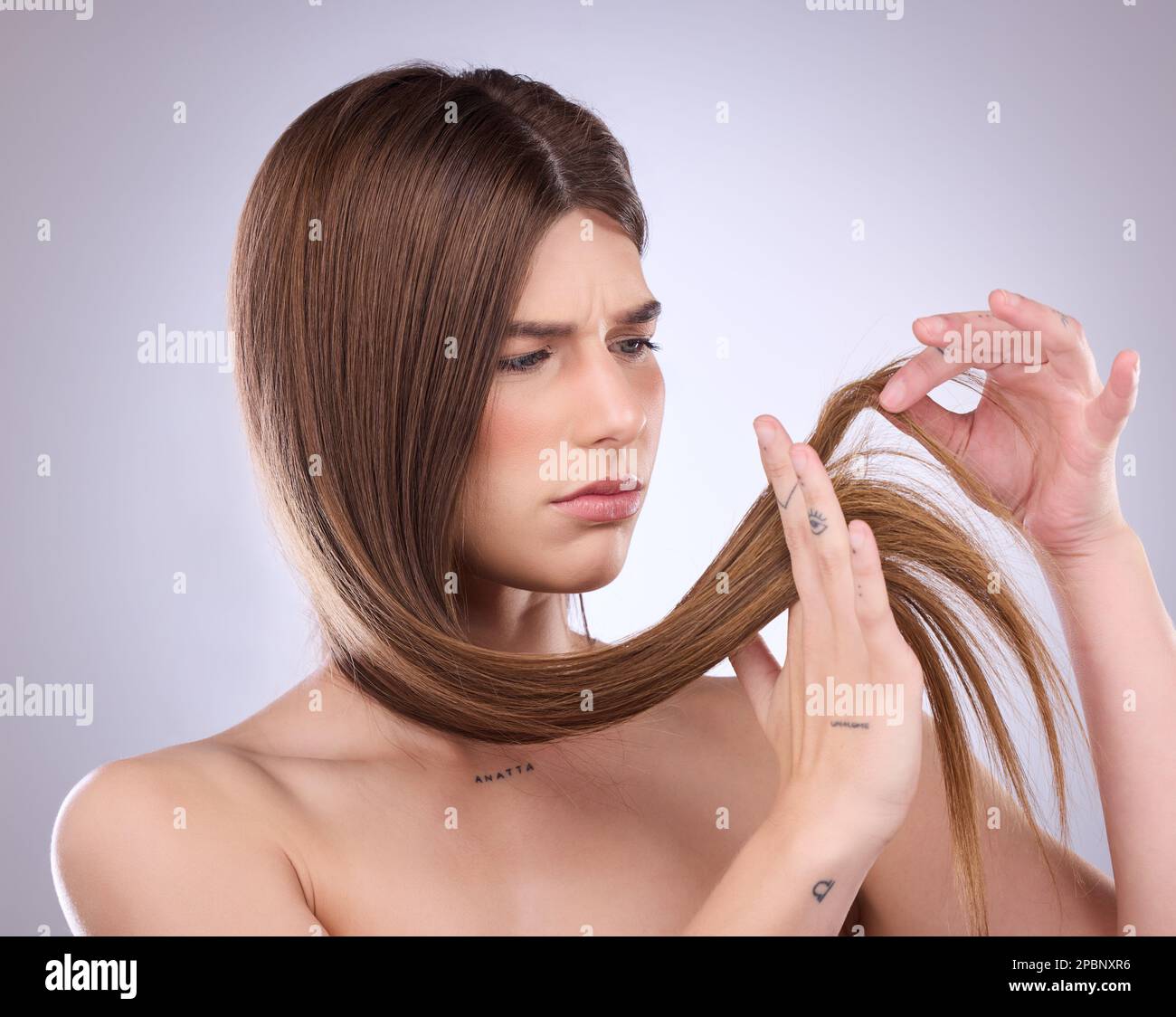 Face, beauty and hair loss of sad woman in studio isolated on a gray background. Angry, haircare and upset female model with keratin hairstyle problem Stock Photo
