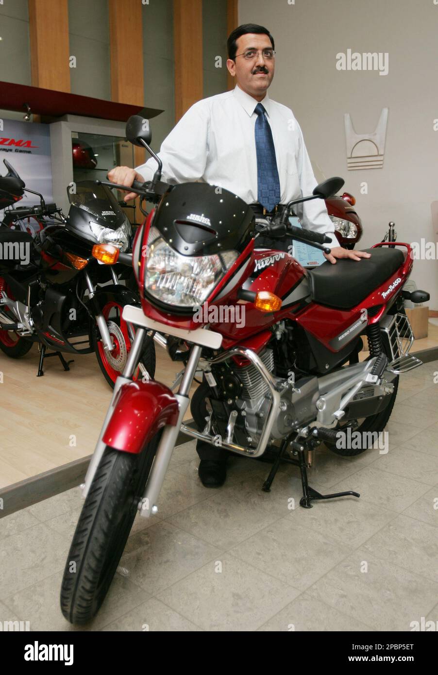 Anil Dua Vice President Marketing of Hero Honda Motors Ltd. poses with the redesigned Achiever in New Delhi India Friday March 30 2007. The new Achiever comes with 5 spoke black color cast