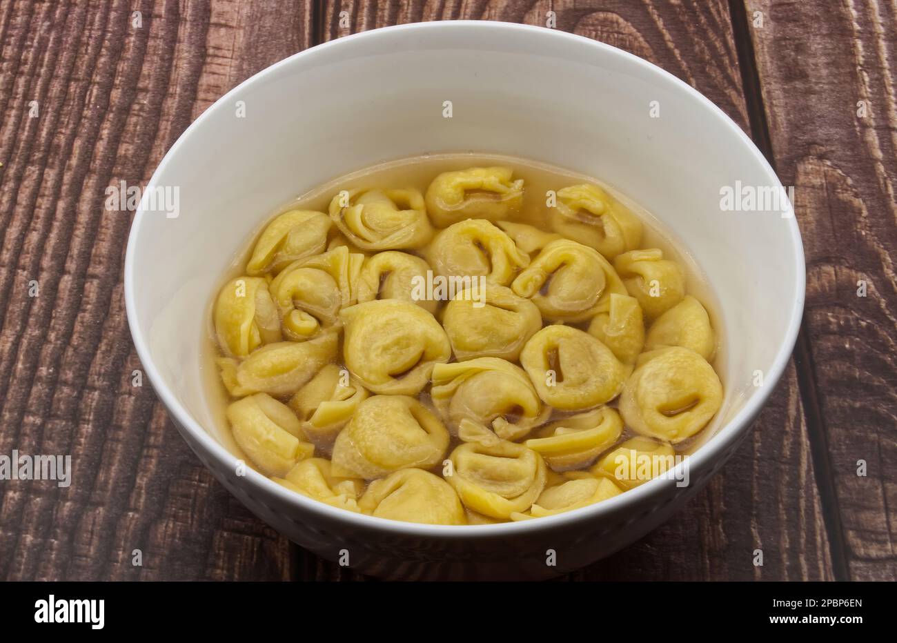 Traditional Italian Tortellini in brodo on wooden table Stock Photo Alamy