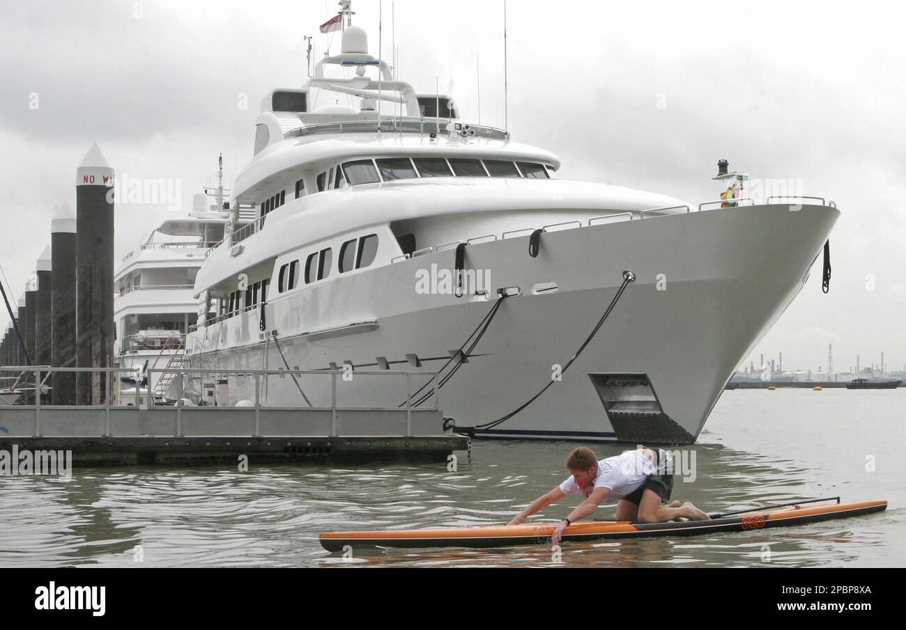 Australian athlete and teacher Jackson English paddles past a luxury