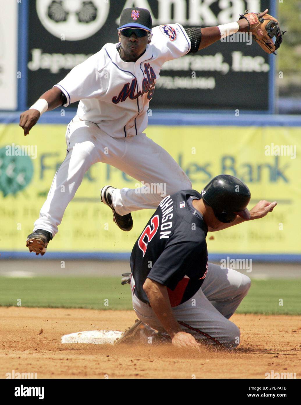 Atlanta Braves' Kelly Johnson (2) is forced at second as New York Mets'  Ruben Gotay, left, throws to first to put out Edgar Renteria and complete a  double play during the second