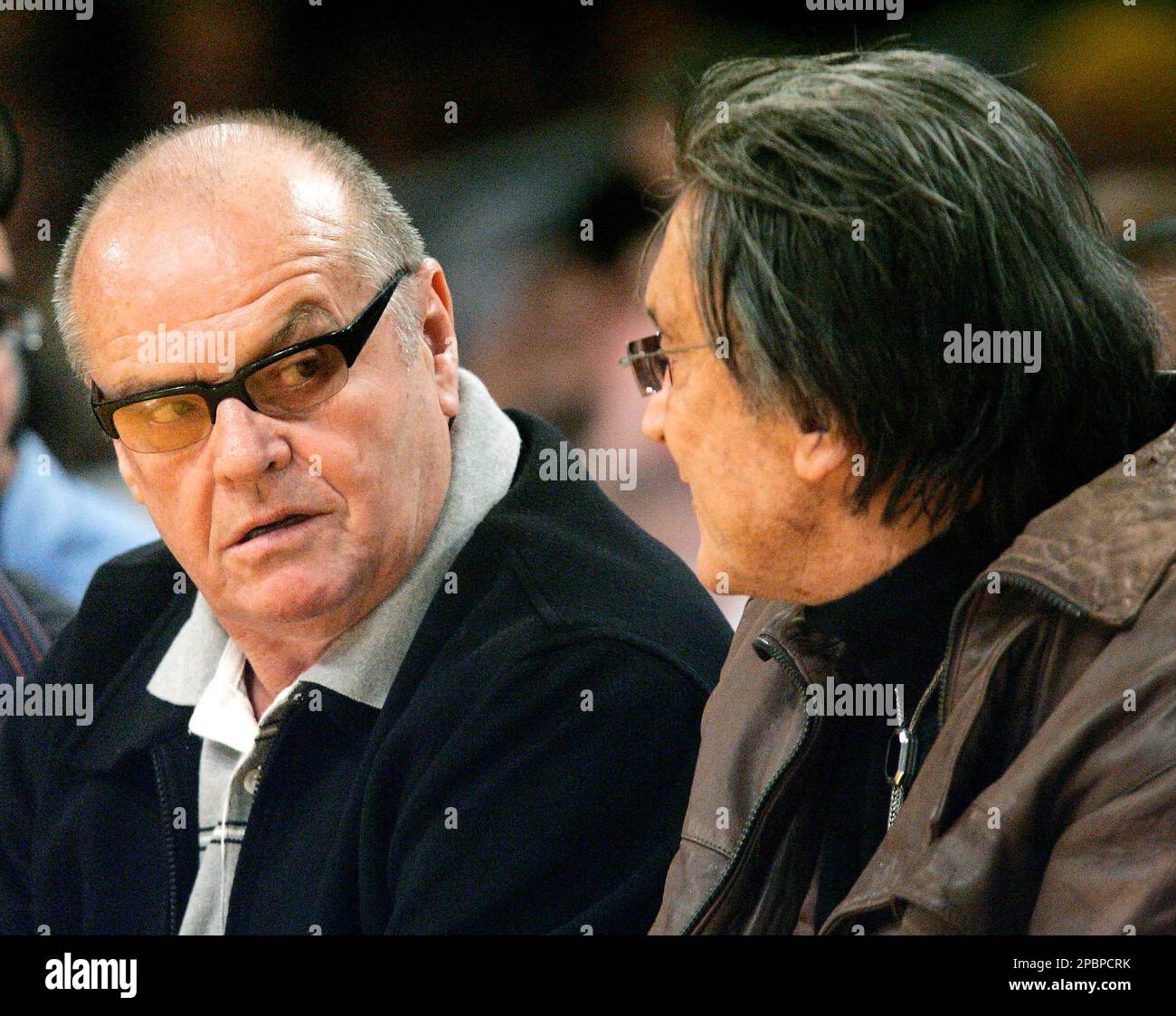 Actor Jack Nicholson, left, seated courtside with producer Robert Evans ...