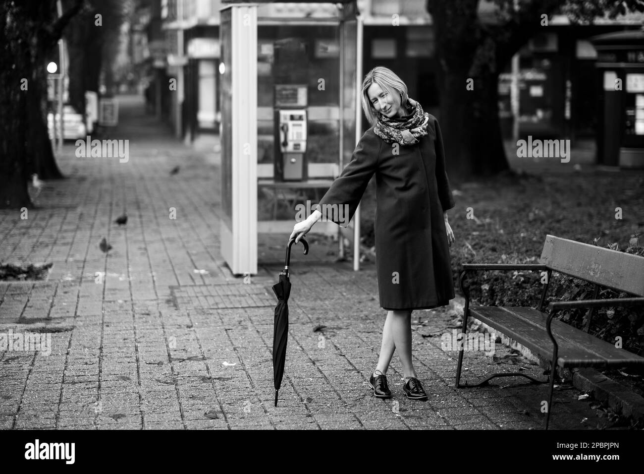 A woman posing with an umbrella. Black and white photo Stock Photo Alamy