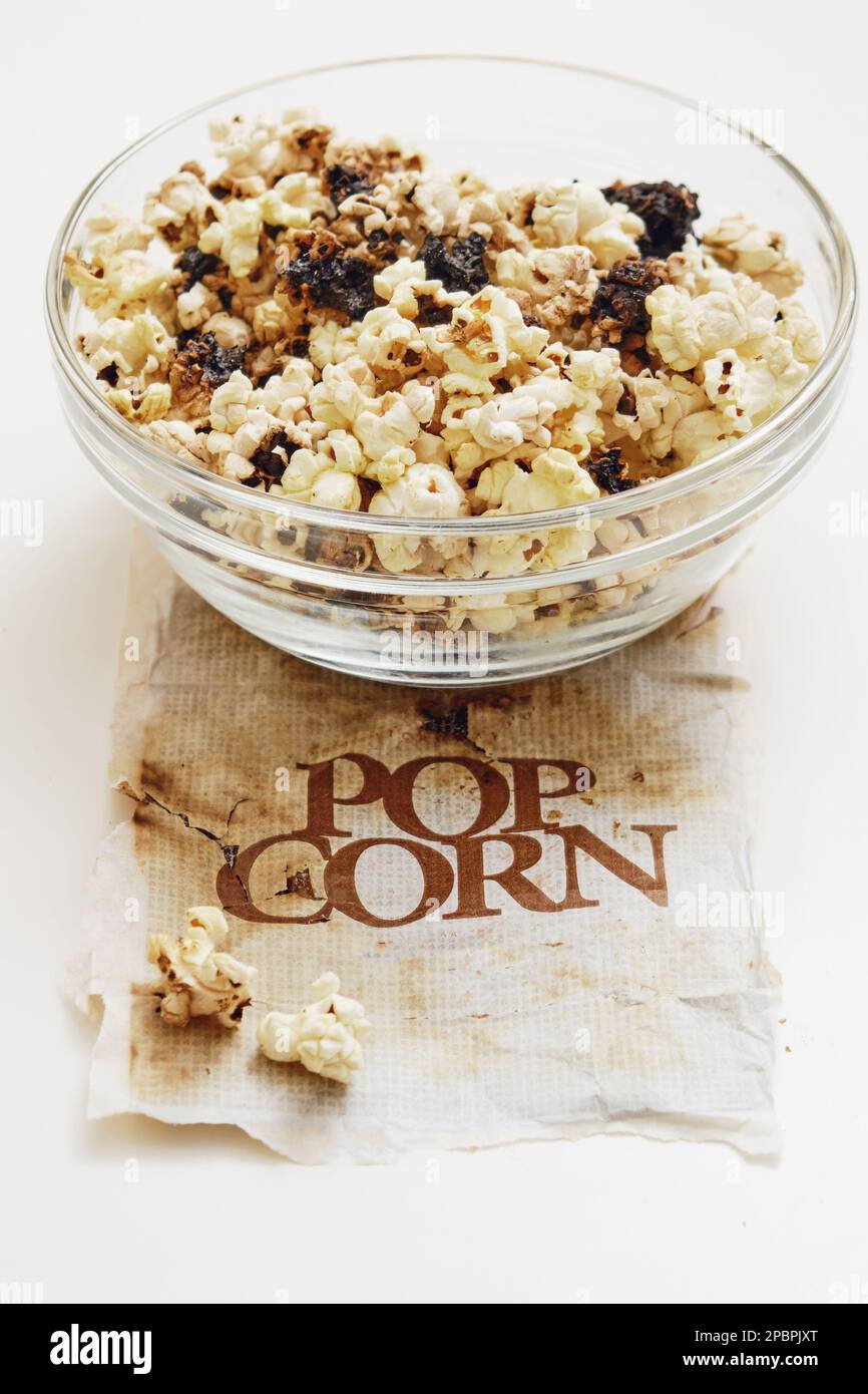 Burnt popcorn from a home microwave. Burn corn kernels on the kitchen