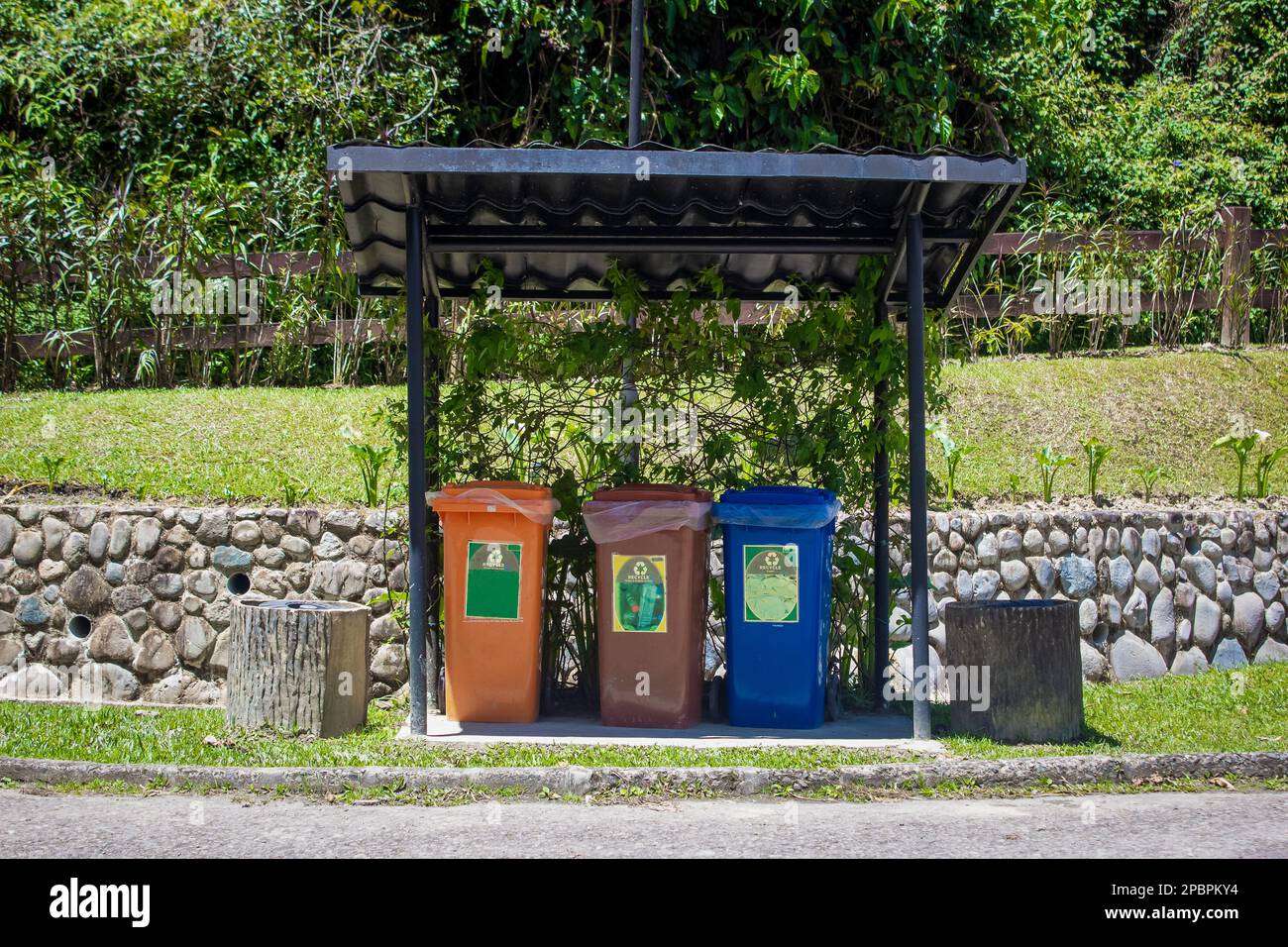 Separate thrash bins for aluminum cans, glass, plastic bottles and