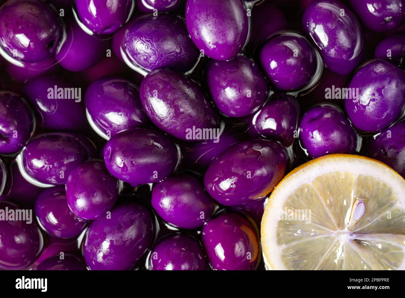 Olive with blueberries flavor. Closeup pile of purple kalamata olives