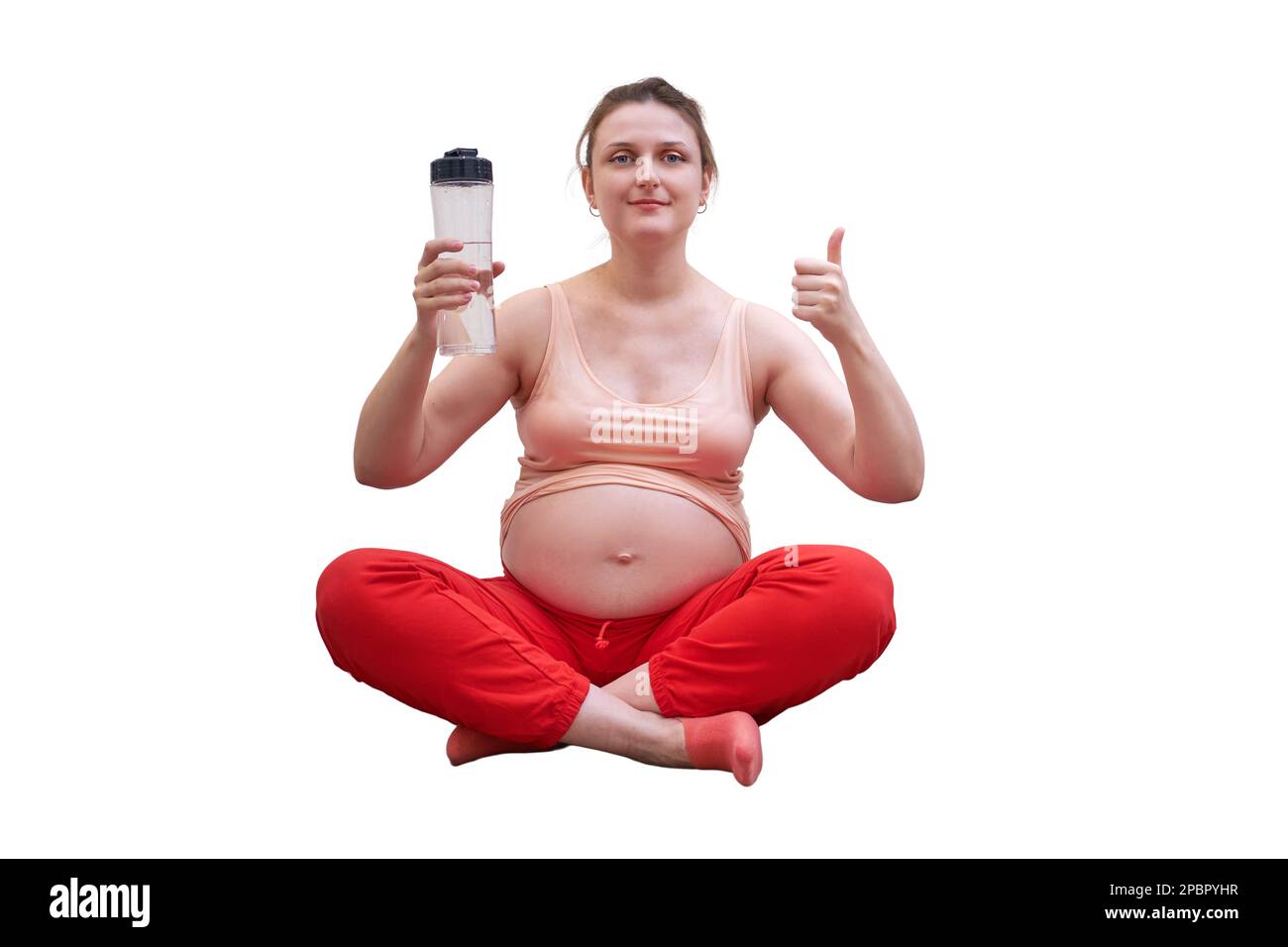 Fitness during pregnancy and the benefits of clean water, isolated on a white background. Pregnant woman at sports training at home shows the thumbs u Stock Photo