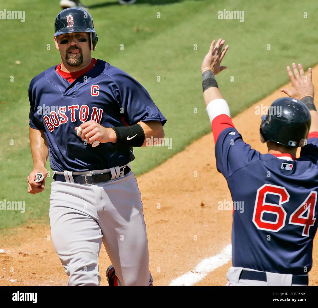Boston Red Sox's Jason Varitek scores on a fifth-inning, two-run single by  teammate J.D. Drew against the Pittsburgh Pirates in spring training  baseball action at Bradenton, Fla., Wednesday, March 21, 2007. At