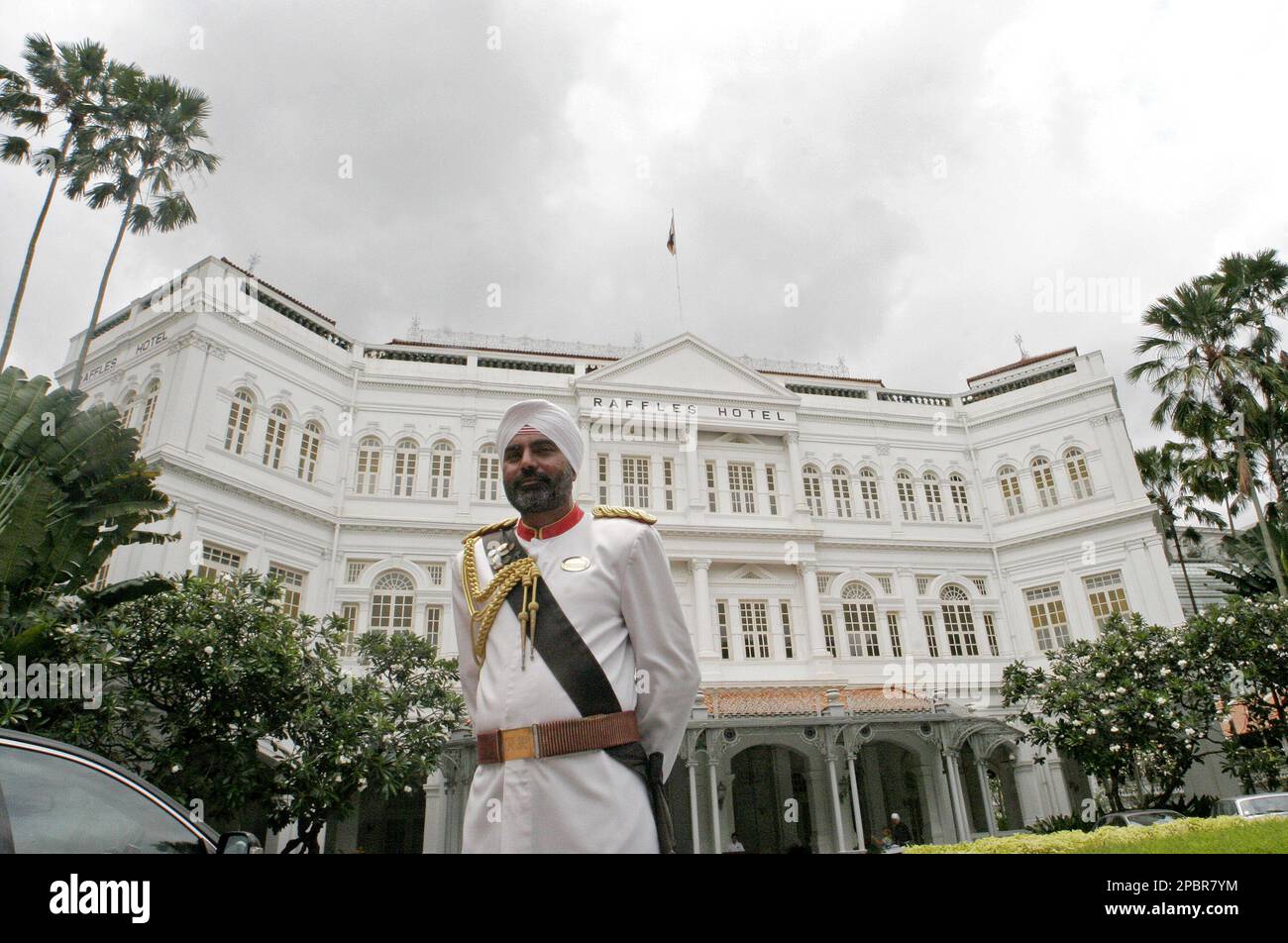 Raffles Hotel's iconic sikh doorman stands in front of the hotel ...