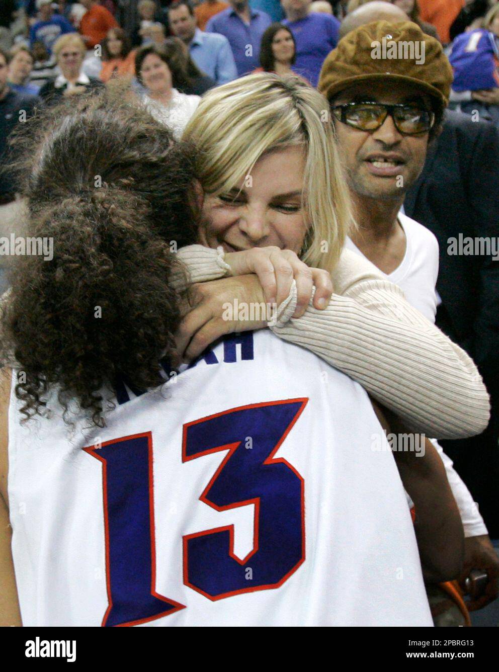 Florida's Joakim Noah hugs his mom Cecilia Rodhe, with his dad Yannick Noah  standing in the background, after Florida defeated Purdue in the second  round of the NCAA Midwest Regional basketball tournament