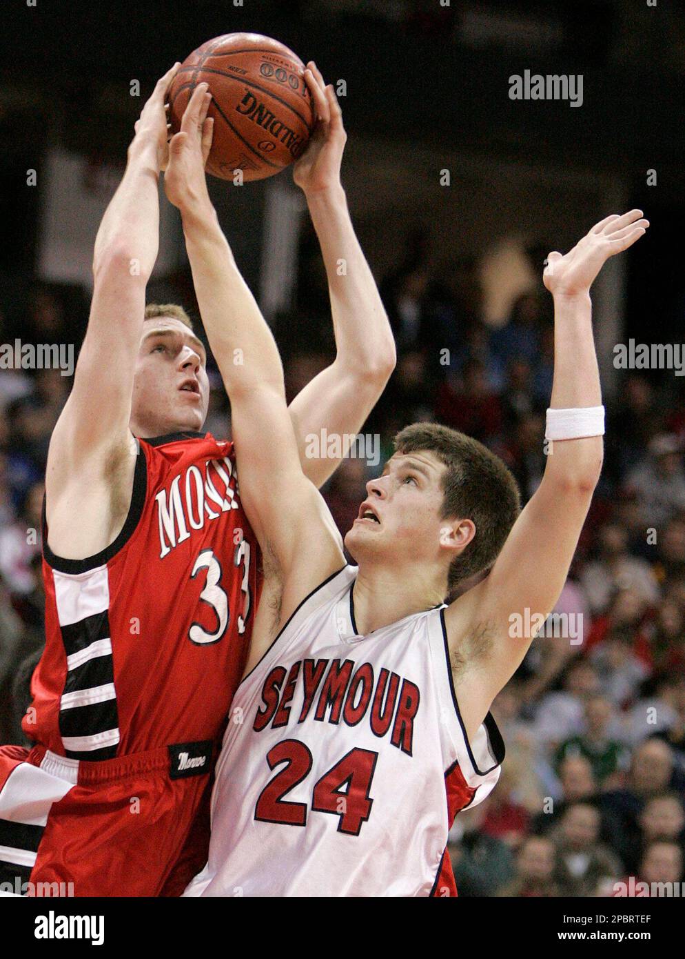 Seymour's Matt Hackl (24) fouls Monroe's Tony Cates during the first half  of a Division 2 semifinal WIAA state tournament basketball game Friday,  March 16, 2007, in Madison, Wis. (AP Photo/Andy Manis
