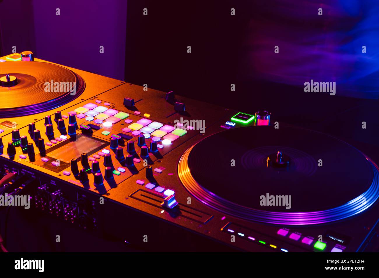 Close up of DJ mixing console in party light Stock Photo - Alamy